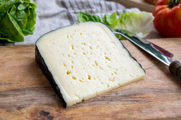 Cheese collection, French fol epi  cheese with many little holes, etorki, tomme noire des pyrenees and ossau iraty cheese