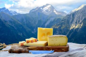 Cheese collection, French beaufort, abondance, emmental, tomme de savoie cheeses served outdoor in...