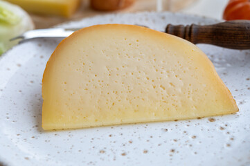 Cheese collection, French fol epi  cheese with many little holes, etorki, tomme noire des pyrenees and ossau iraty cheese
