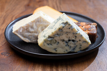 Cheese collection, blue cheese, camembert, brie served as dessert with fig almonds bread