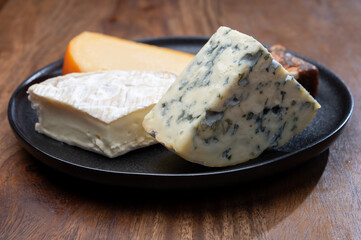 Cheese collection, blue cheese, camembert, brie served as dessert with fig almonds bread