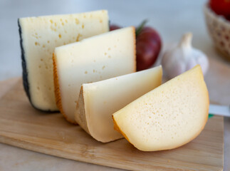 Cheese collection, French fol epi  cheese with many little holes, etorki, tomme noire des pyrenees and ossau iraty cheese