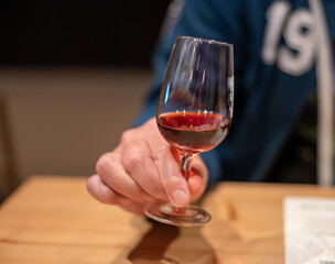 Professional tasting of different fortified dessert ruby, tawny port wines in glasses in porto cellars in Vila Nova de Gaia, Portugal