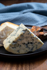 Cheese collection, blue cheese, camembert, brie served as dessert with fig almonds bread