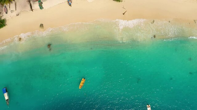 Aerial view of boats in turquoise water on beach at Asu Island, North Sumatra, Indonesia
