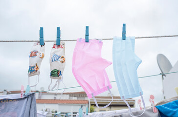 Family washable face masks hanging on a clothesline