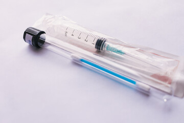 A syringe with a test swab inside a test tube