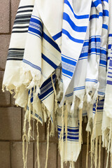 Vertical Image of Many Prayer Shawls Hanging in Jewish Synagogue