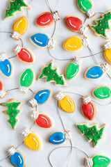 Top down of various Christmas cookies scattered against a light background.