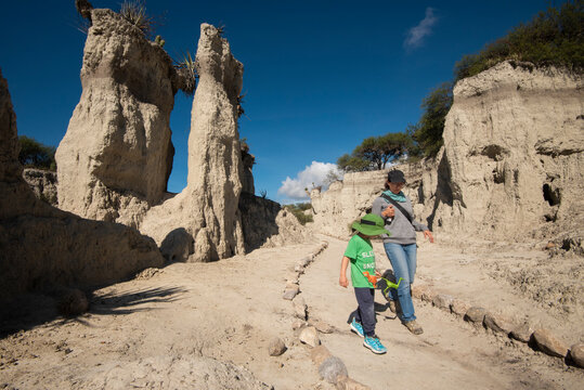 Mom and her son hiking on a trail in the desert near San Juan Raya