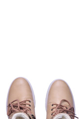 Two beige winter boots lie with socks up on a white background under clipping