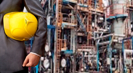 Worker engineer Man work in oil or gas refinery, turning on and off the pipeline valve torso and hand engineer yellow helmet for workers security construction worker No face Unrecognizable person