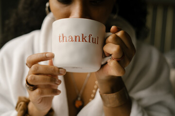 Woman drinking coffee at home in bed