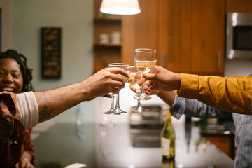 Happy friends toasting drinks and celebrating good times together