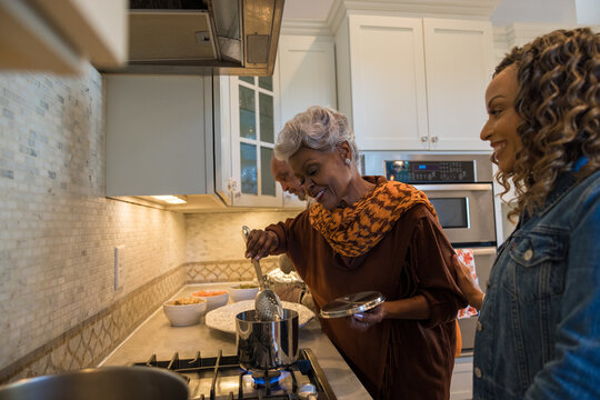 Black mother and daughter cooking in the kitchen