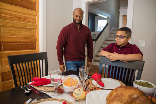 Father and son look at Thanksgiving meal
