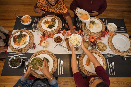 Overhead view of black hands eating Thanksgiving holiday meal
