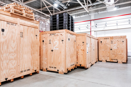 Wooden boxes in the warehouse. Boxes out of wood for packing industrial machinery. Warehousing. Packaging of finished products of the plant. Sale of packaging materials.