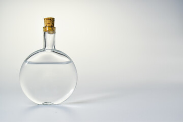 Empty glass bottles on a light background. Vessel for perfumes and cosmetics