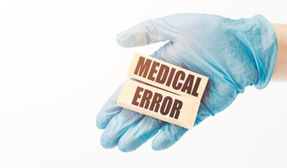 Doctor holding a wooden cubes with text Medical Error, medical concept