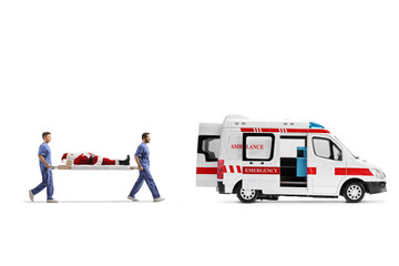 Full length profile shot of healthcare workers carrying  Santa claus ona a stretcher into an ambulance