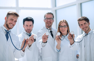 group of doctors hold their stethoscopes