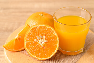 Fresh Honey Murcott orange fruit and juice on wooden background, Healthy drink