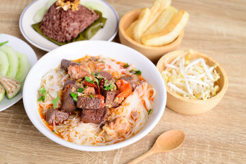 Northern Thai food (Kanom Jeen Nam Ngeaw), Rice noodles spicy soup with pork and pork blood eating with fresh vegetables and pork rind