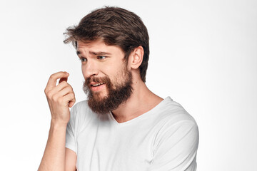 cheerful emotional bearded man gesturing with his hands close-up light background