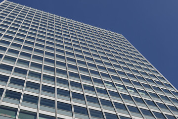 Low angle view of glass facade with rectangular windows frame structure system of modern style office building. Abstract Architectural Geometry elements. Mood of urban metropolis concept.