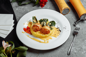 Mashed potatoes with cheese balls in sauce. cheese balls breaded and deep fried. Deep-fried cheese balls