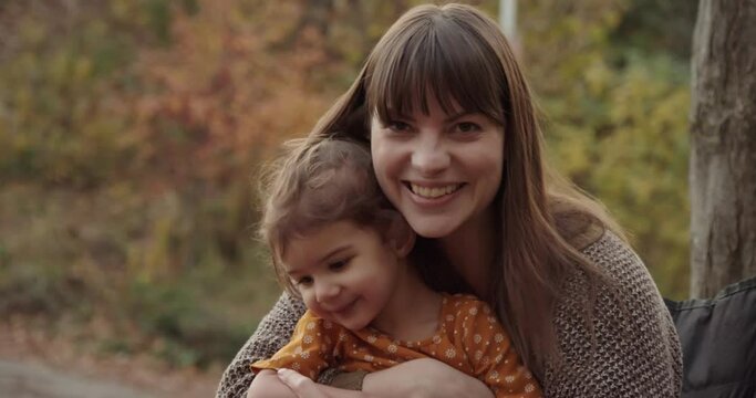 Mother enjoying fall day with toddler girl. Cinematic 4K footage.