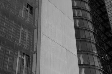 Black and white tone, Exterior architectural detail of mixture facade elements and material of modern office buildings. Abstract Urban metropolis background.