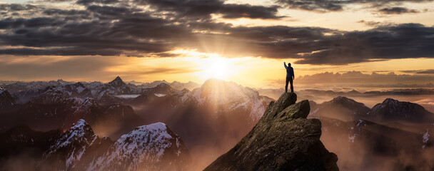 Magical Fantasy Adventure Composite of Man Hiking on top of a rocky mountain peak. Background...