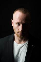 Fototapeta premium Portrait of stylish handsome young man. Fashion guy on black.