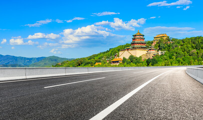 Fototapeta na wymiar Empty asphalt road and the Summer Palace scenery in Beijing.