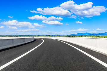 New asphalt road and green mountains with city skyline natural landscape in the city suburbs.