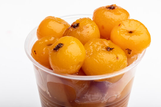 Disposable cup of tejocotes (mexican hawthorn) in heavy syrup as a dessert