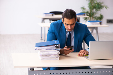 Young male employee sitting in the office