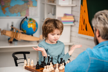 Chess, success and winning. Educational games, early development. Concentrated boy developing chess strategy, playing board game.