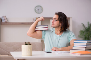 Young male student preparing for exams at home