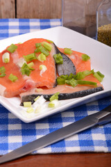 Food concept: red salmon fish, red hot chilli pepper spice with greens. Healthy food cooking.