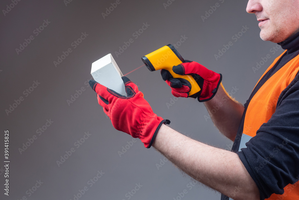 Poster man scans a barcode. human is checking a barcode on a box. concept - classification in stock by barc
