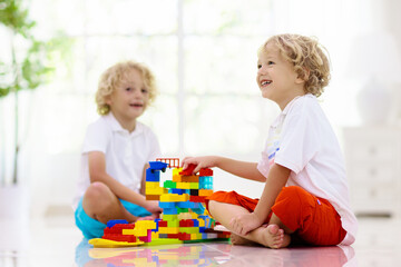 Naklejka premium Child playing with toy blocks. Kids play.
