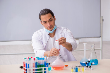 Young male chemist working in the lab