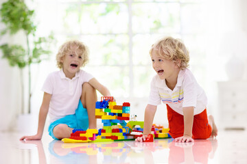 Child playing with toy blocks. Kids play.