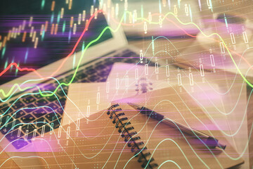 Double exposure of financial chart drawing and desktop with coffee and items on table background....