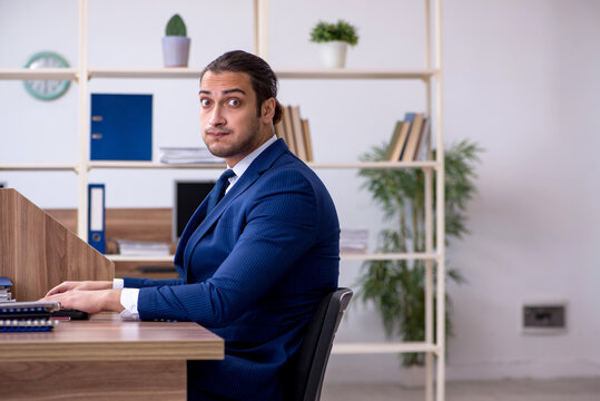 Young male employee working in the office