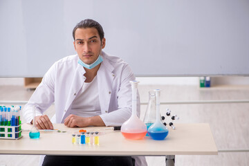 Young male chemist working in the lab