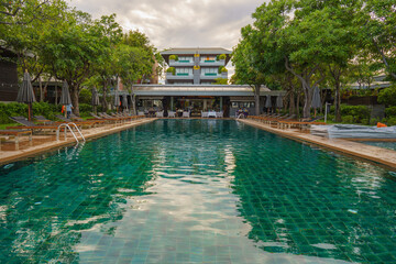 Fototapeta na wymiar beachfront resort and hotel with foreground of swimming pool